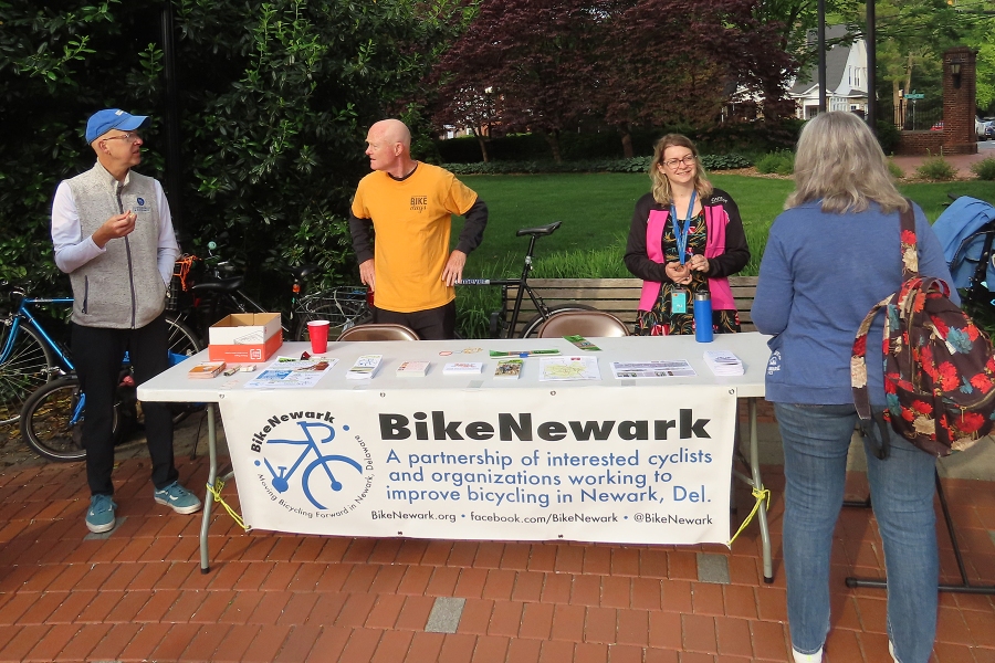 The four BikeNewark members standing around the event table
